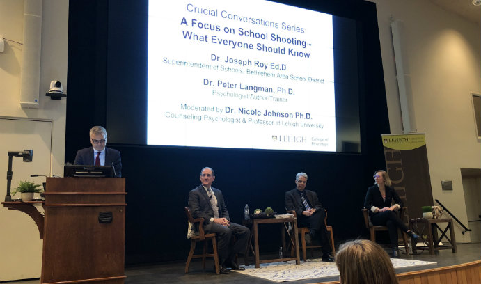 College of Education Dean William Gaudelli speaking at a podium