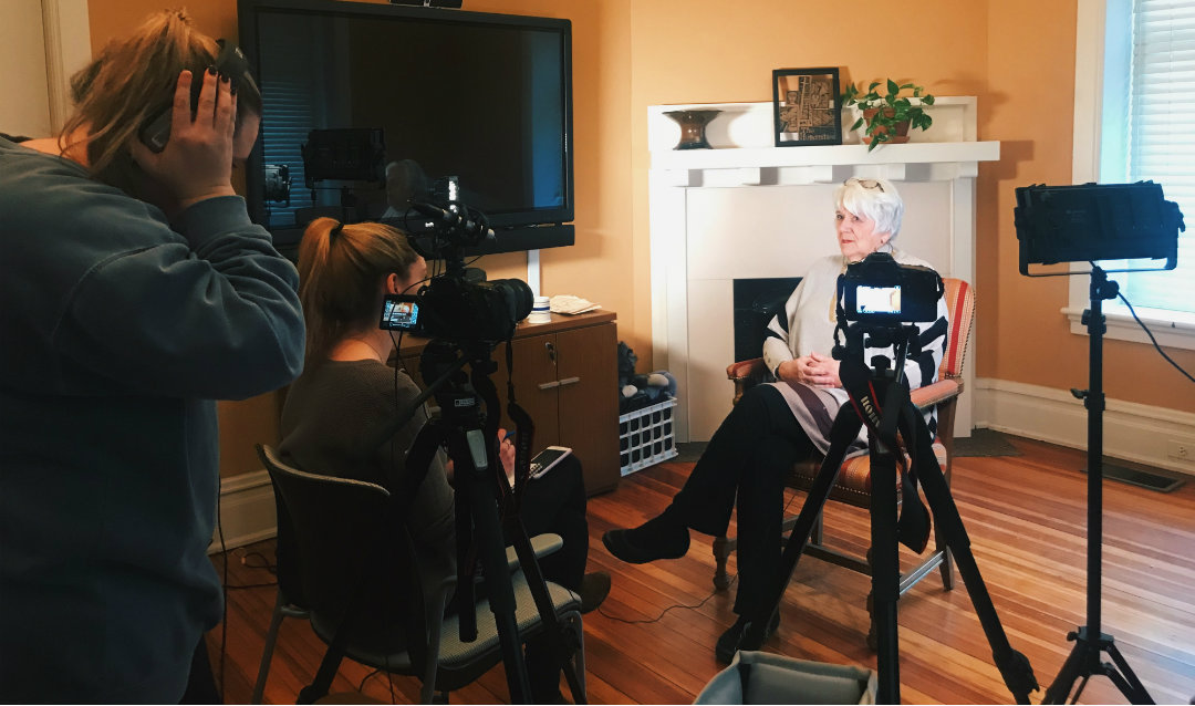 Kari Moffat and Caroline Kelliher interviewing a community member named Connie for their documentary fim