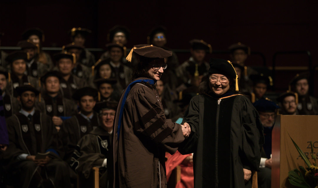 Professor Julie Miwa hoods Kristin Rae Anderson