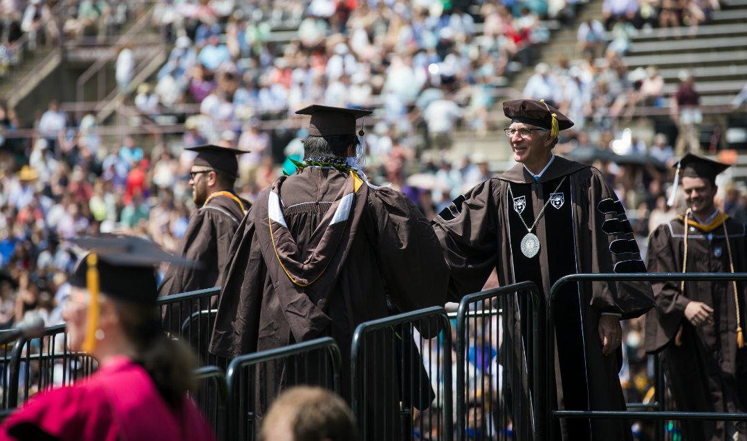 Student shakes President John Simon's hand at Lehigh University commencement