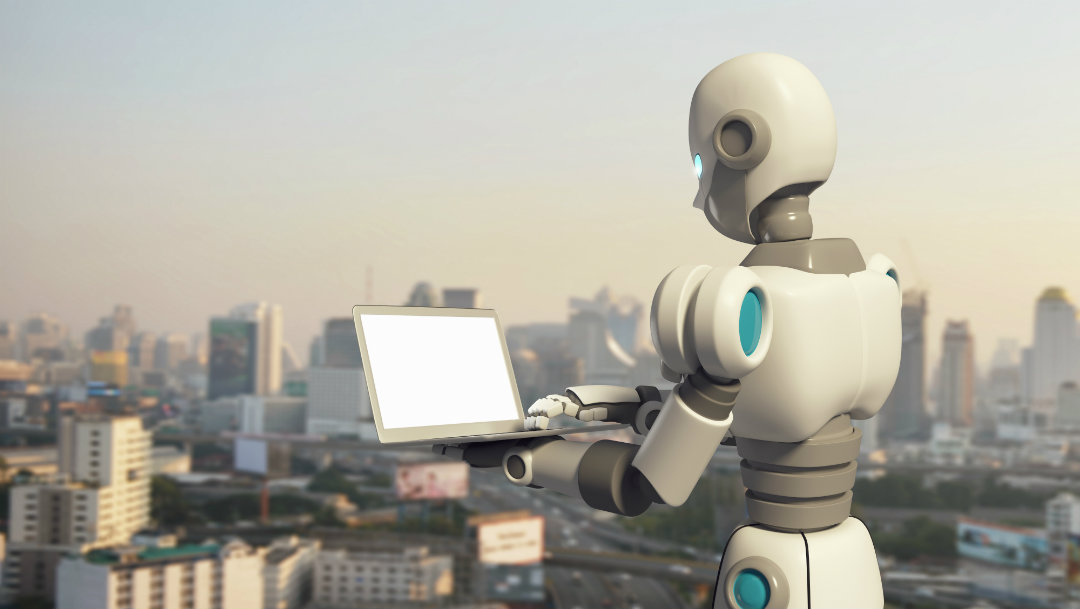 Robot working on a laptop computer overlooking a city skyline