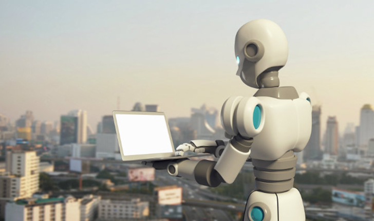 Robot working on a laptop computer overlooking a city skyline