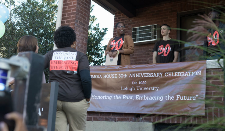 Dahlia Hylton, director of the Office of Multicultural Affairs, addresses those attending the Umoja House honor walk.