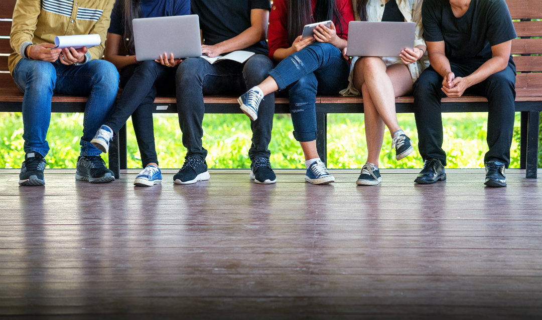 Students lined up on bench