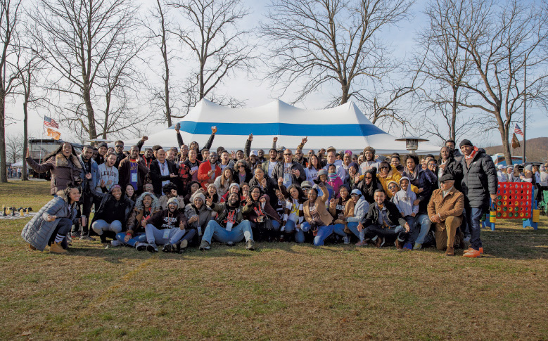 Group of people posing in a field