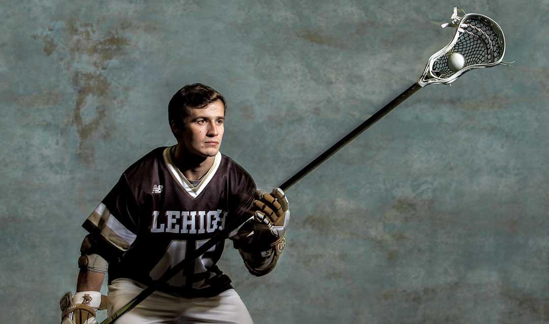 Teddy Leggett posing with his lacrosse stick 