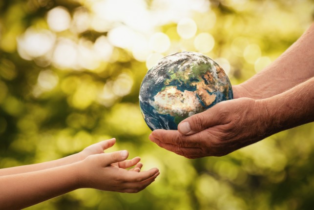 Stock photo of person holding a globe