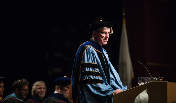 Lehigh University provost Patrick Farrell speaking at an event wearing academic regalia.