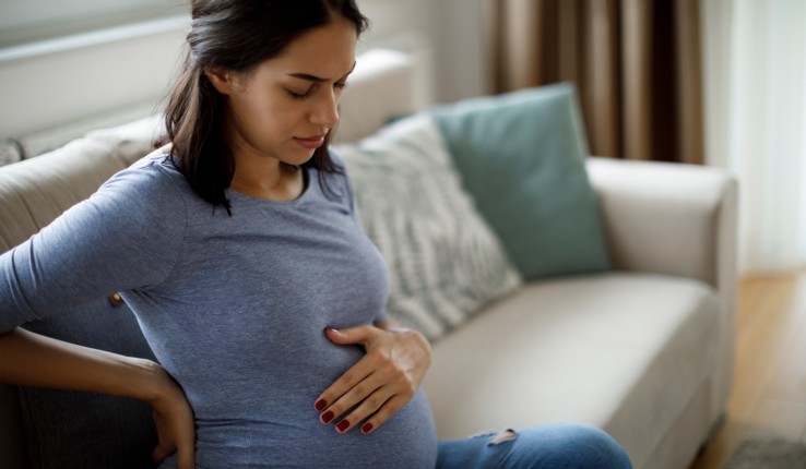 Pregnant woman touching her stomach