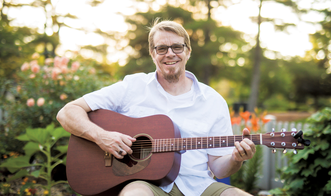 Robert Flowers plays guitar