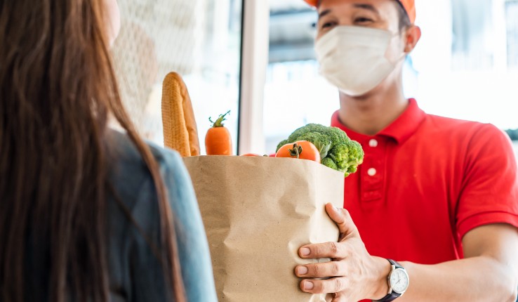 man in mask delivers groceries