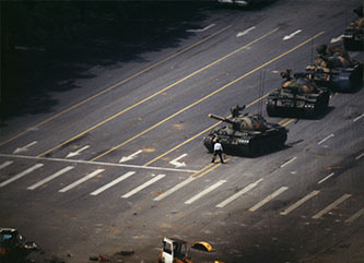 Person standing in front of tanks