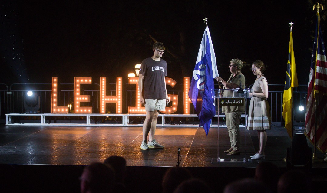 Ethan Riester '25 accepts his class's flag