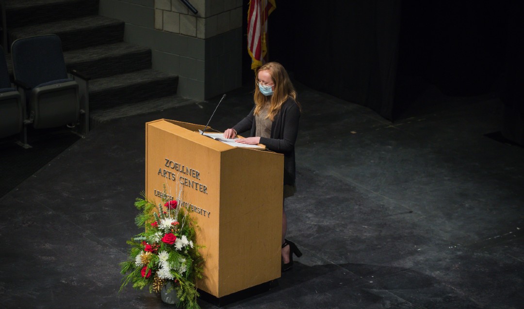 Kelby Anderson speaks at podium