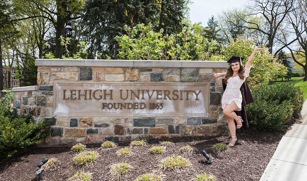 Anastasia Citsay ’22 poses on campus with her cap and gown.