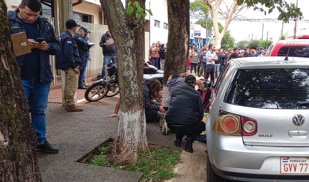 Above, members of Paraguayan police tend to a journalist killed in 2022 in Pedro Juan Caballero.