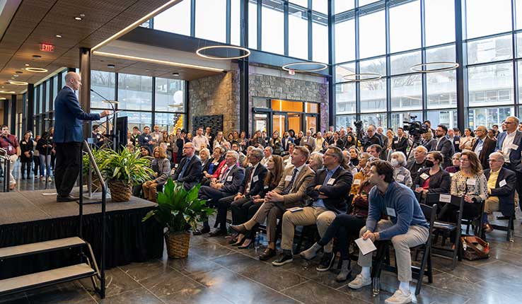 McKay Price speaks to attendees at the open house