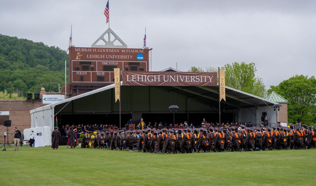 Commencement stage with graduates seated in front