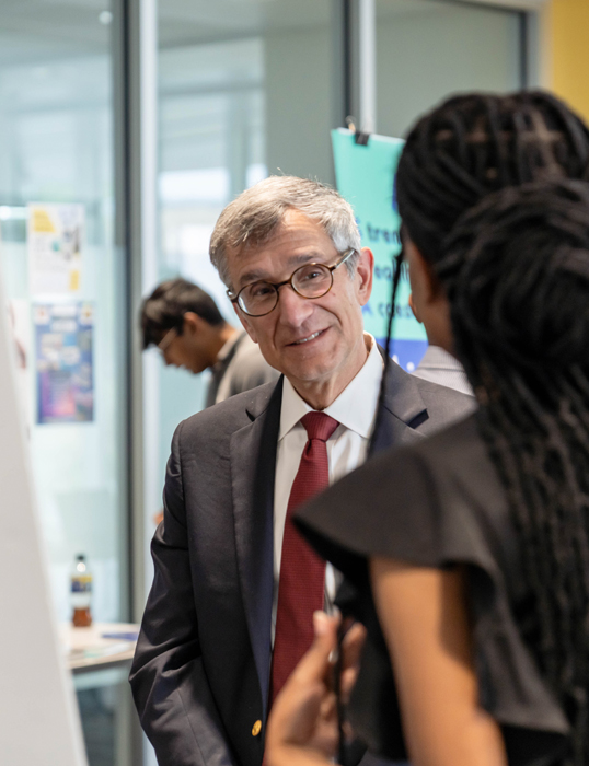 President Joseph J. Helble ’82 speaks with student