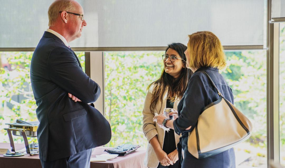 Provost Nathan Urban talks with people at reception