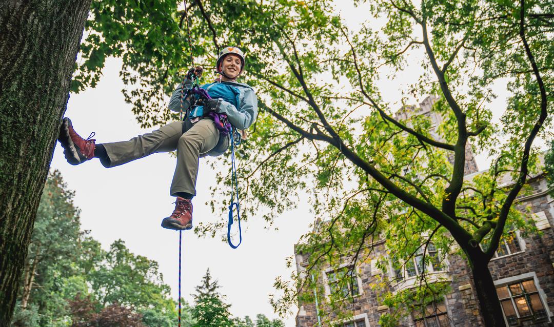 Michelle Elise Spicer ’12 ’14G, assistant professor of earth and environmental science, demonstrates to student mentees how to safely climb trees.