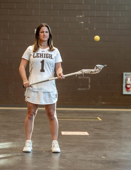 Gabby Schneider tossing lacrosse ball in air