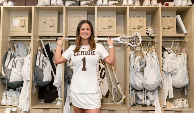 Gabby Schneider posing with lacrosse stick