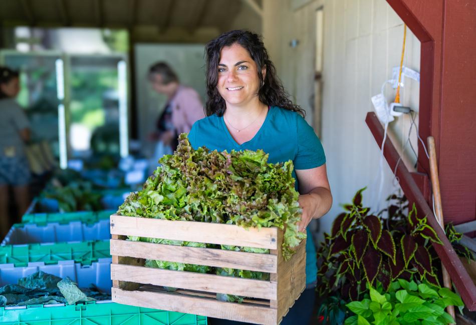 Jessica Salvaterra carrying box of produce