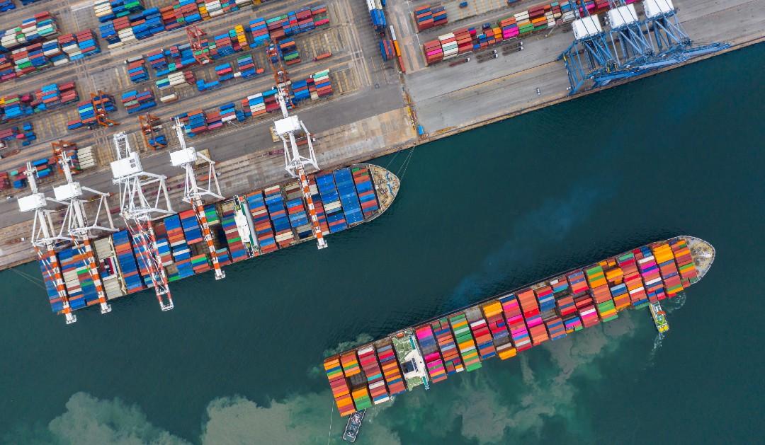 Aerial view industrial port with containers and container ship