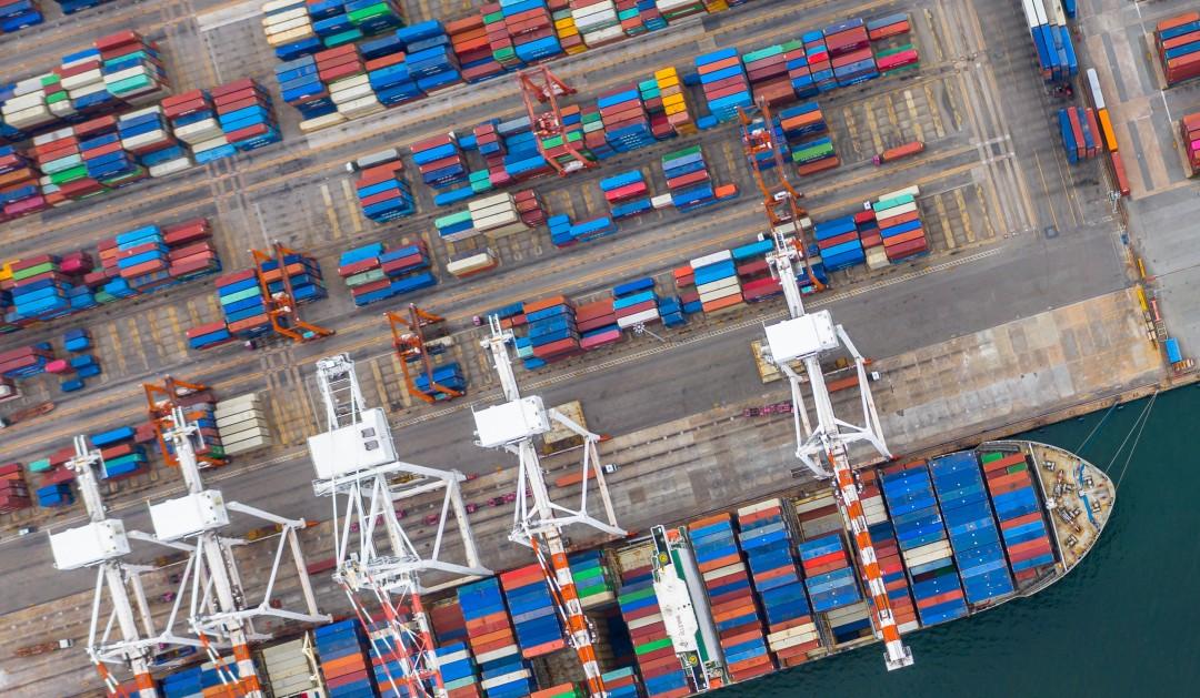 Aerial view industrial port with containers and container ship