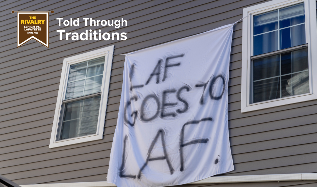 Bedsheet banner reading "Laf goes to Laf" hangs from brown siding between a pair of windows.