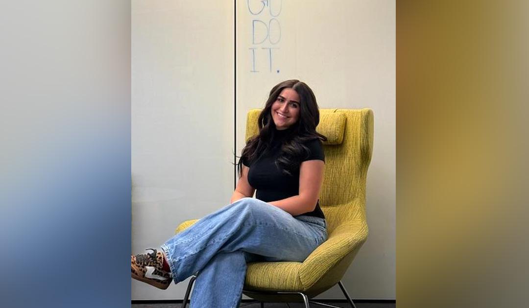 Student sits in chair.