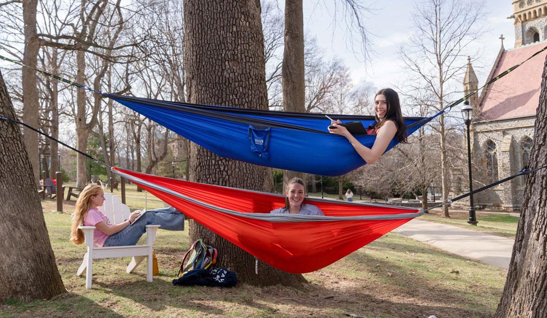 Students sitting in hammocks.