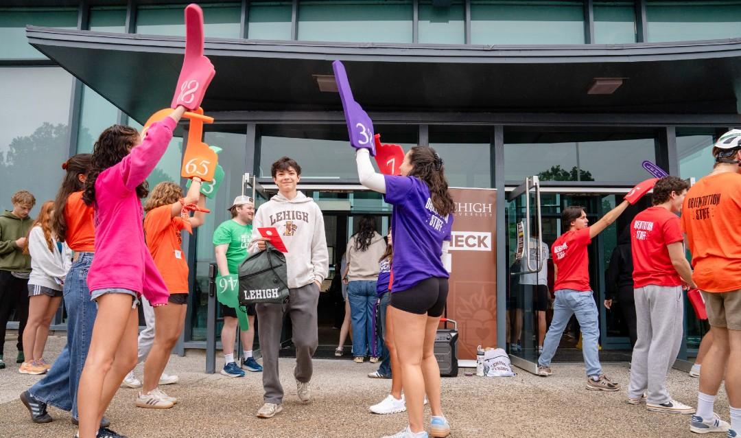 Volunteers cheering for new students