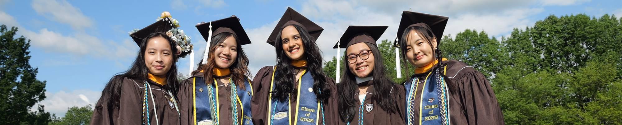 Graduates posing for a photo at commencement