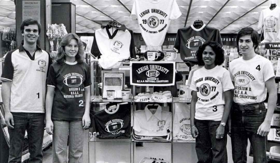 Four students model T-shirts commemorating Lehigh Football’s 1977 National Championship win.