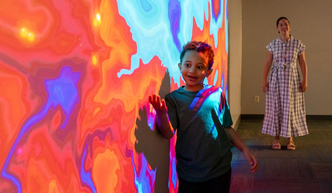 Student in front of projection on wall