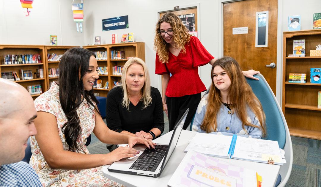 Teachers around a computer