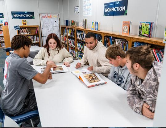 Students at table with teacher