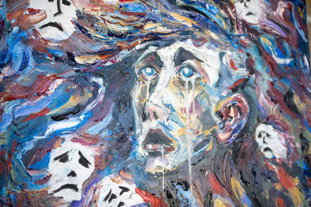 Abstract art of ghoulish faces in a painted medium