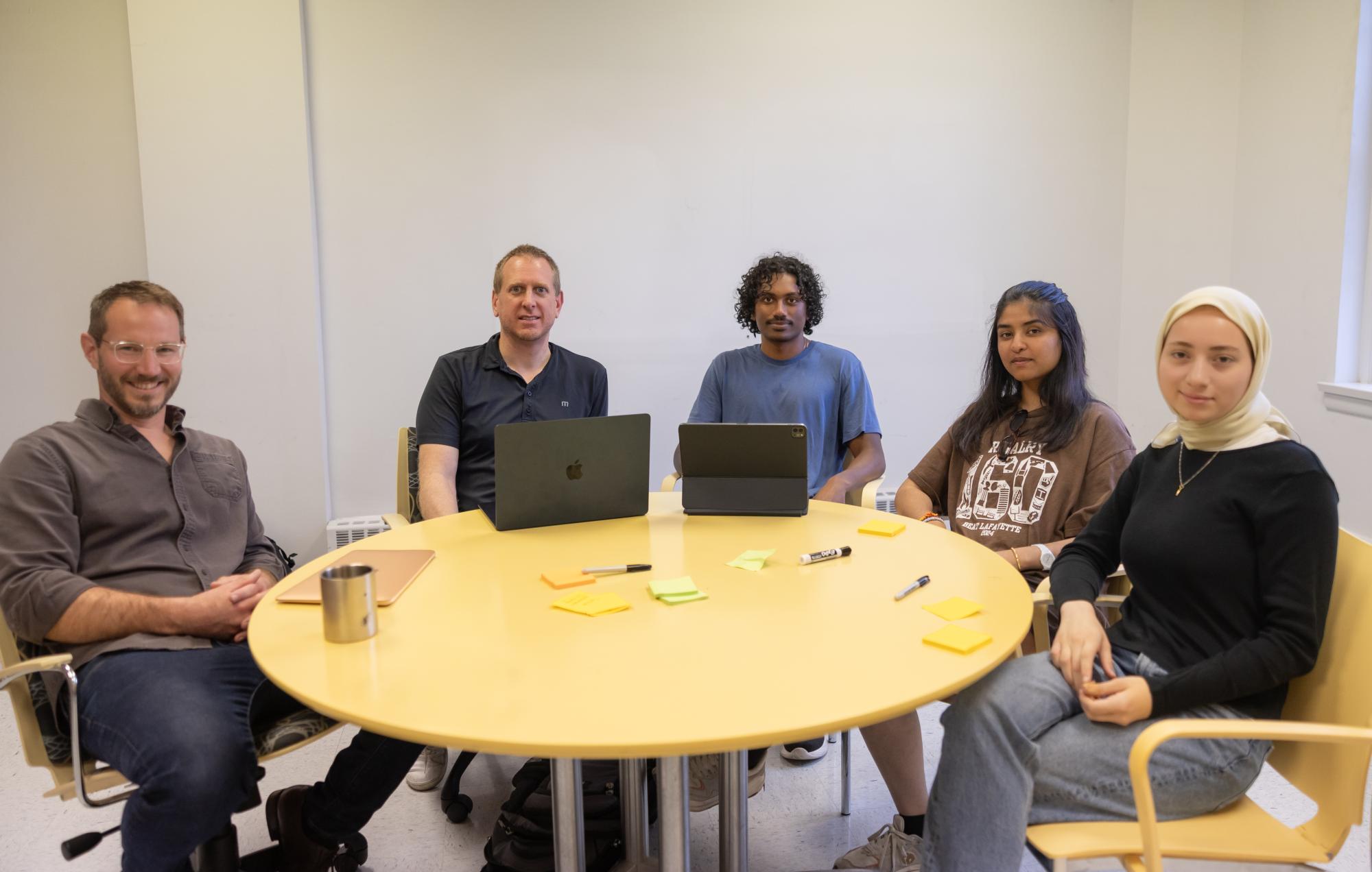 The Venture Studio meeting that depicts, from left to right, Chris Kauzmann ’13, M’14, Frank Balcavage '01, Mithran Moses ’28, Vini Jaiswal ’27, Busra Can ’28.