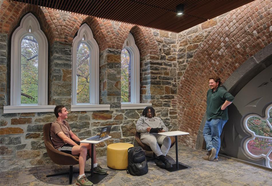 Three students gather in stone room in Clayton University Center.