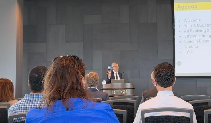 A man at a podium speaking to an audience.
