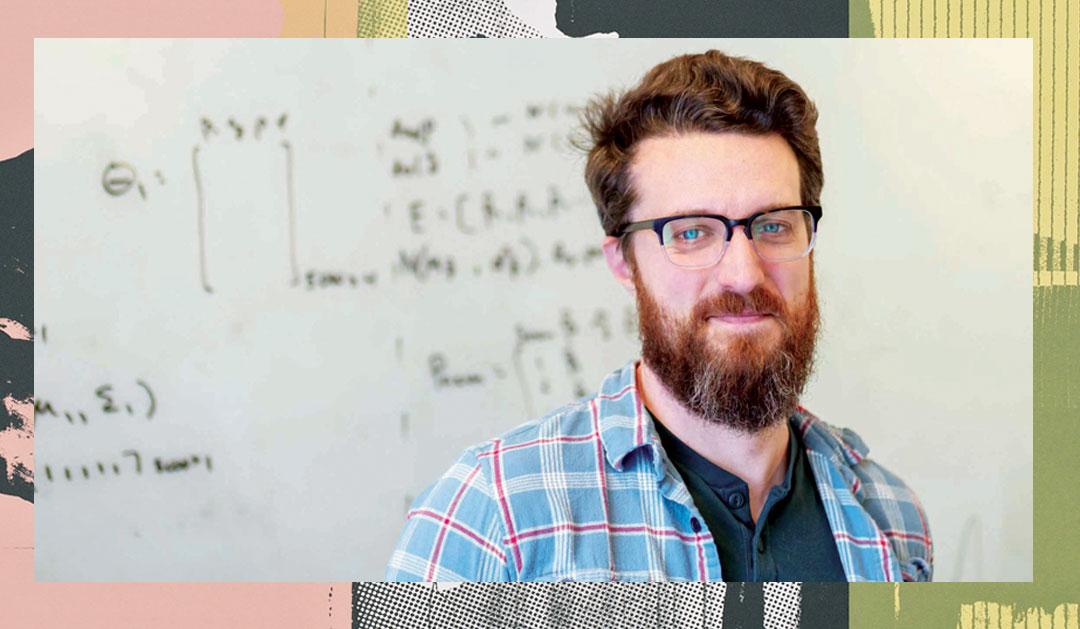 Thomas McAndrew posing in front of a whiteboard