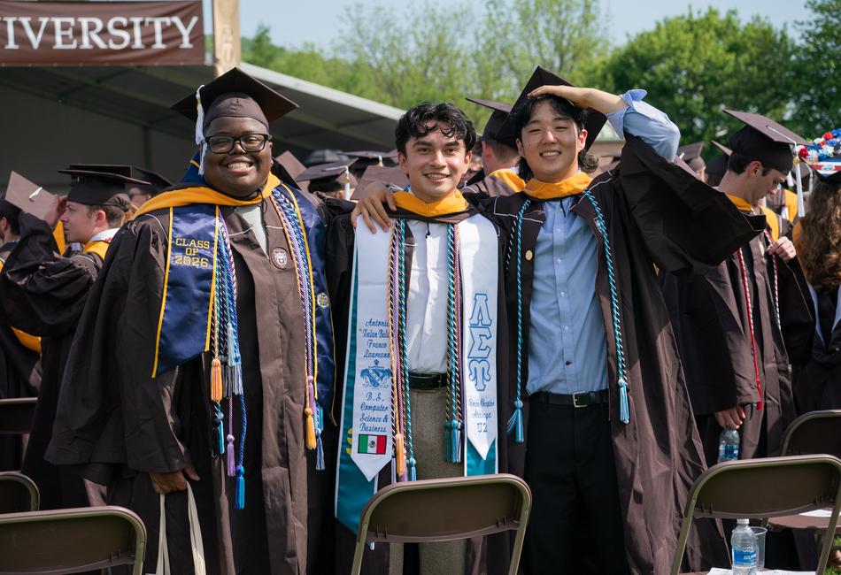 Students gather for a photo while celebrating.