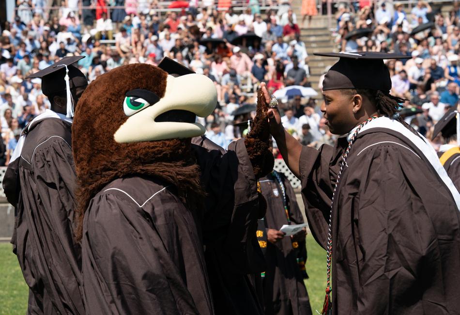 Students interact with Lehigh's mascot, Clutch. 