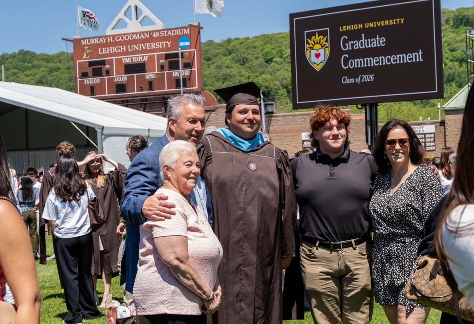 Photograph of a Lehigh University graduate and family at a Commencement ceremony.