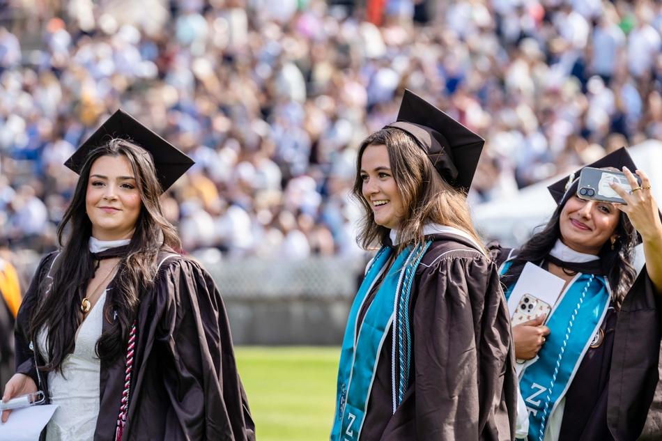 Students smile and wave as they enter Goodman Stadium.