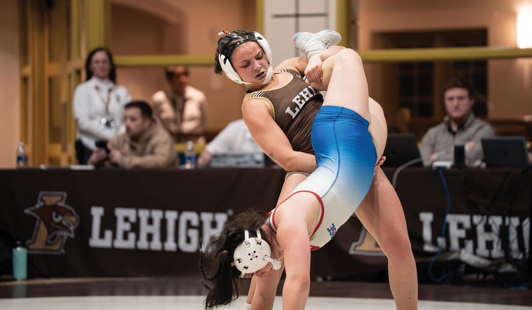 Photograph of two women wrestling; a Lehigh wrestler throws her opponent mid-match.