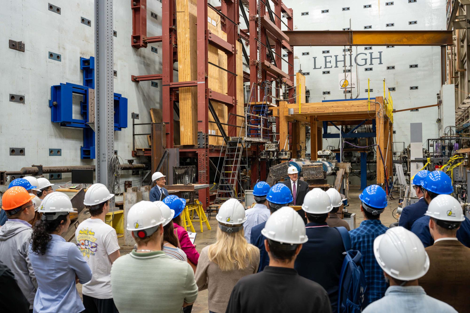 Photograph of a group in hard hats at a Lehigh University structural testing lab.